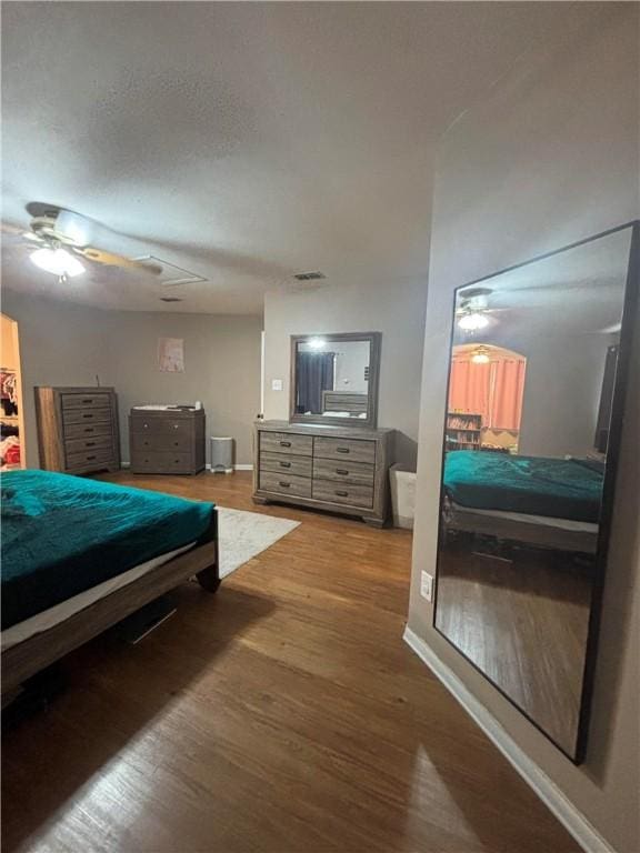 bedroom with hardwood / wood-style floors and ceiling fan