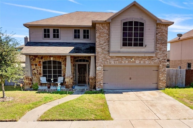 view of front of property featuring brick siding, concrete driveway, a front yard, fence, and a garage