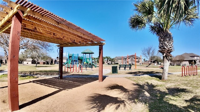 view of yard featuring playground community and a pergola