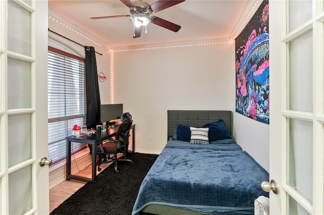 bedroom featuring baseboards, a ceiling fan, and french doors