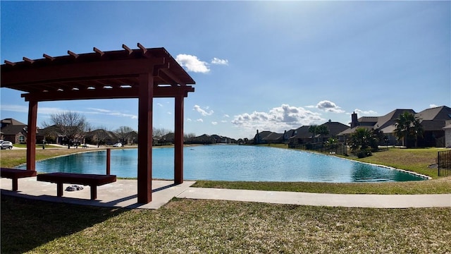 view of swimming pool with a water view, a pergola, and a yard