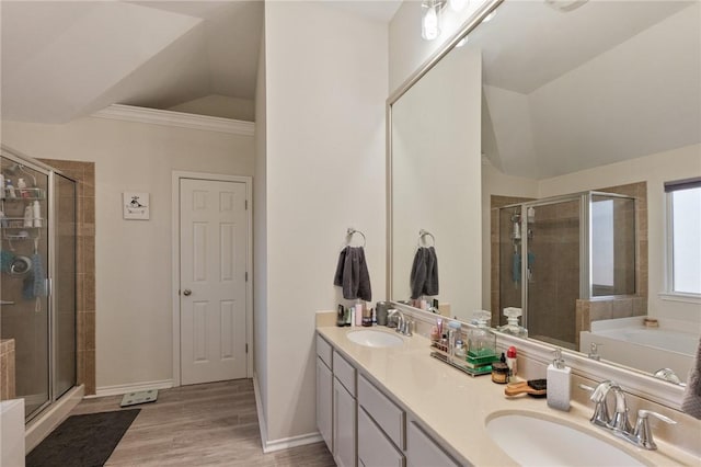 bathroom featuring lofted ceiling, a stall shower, and a sink