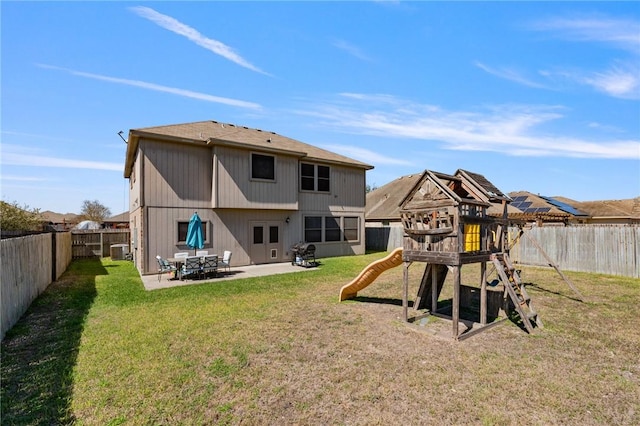 rear view of property with a patio area, a playground, a lawn, and a fenced backyard