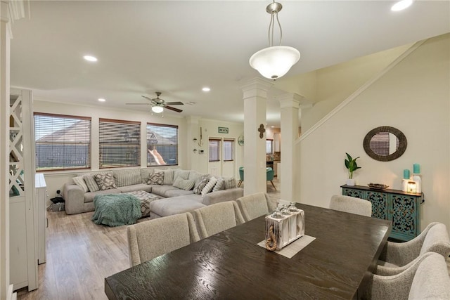 dining room with ceiling fan, wood finished floors, stairs, ornate columns, and recessed lighting