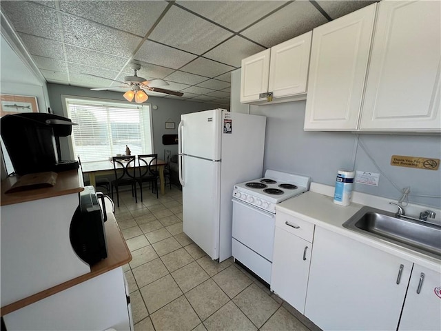 kitchen featuring white appliances, a sink, a paneled ceiling, and white cabinetry