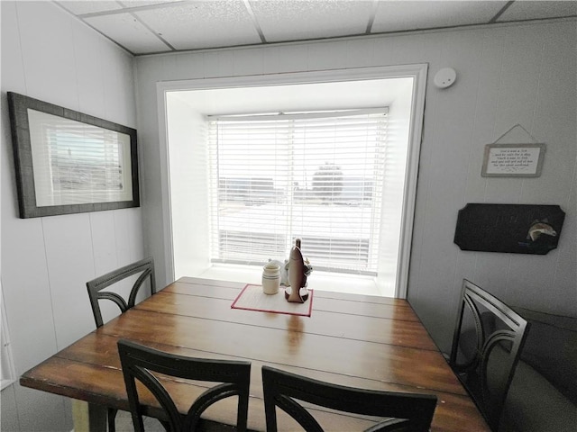 dining area with a paneled ceiling