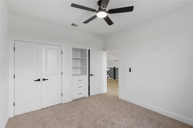 unfurnished bedroom with ceiling fan and light colored carpet