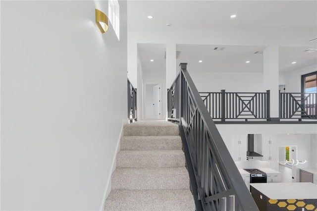 stairway featuring carpet flooring