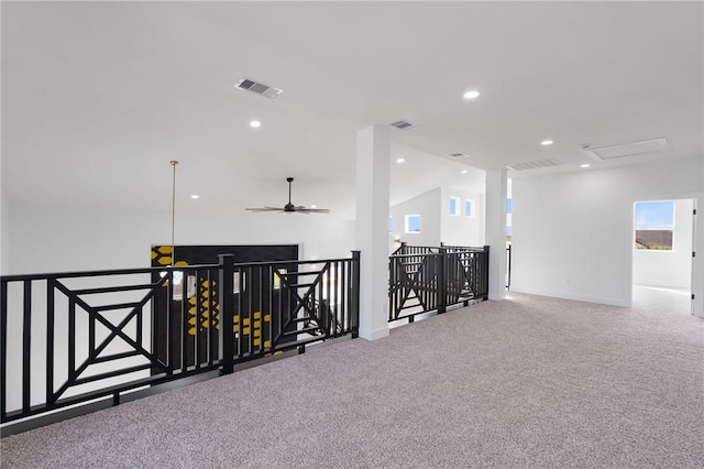 hall with vaulted ceiling and carpet