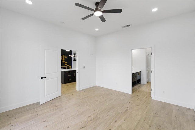 empty room featuring ceiling fan and light wood-type flooring