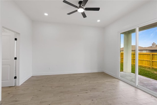 unfurnished room with ceiling fan and light hardwood / wood-style flooring