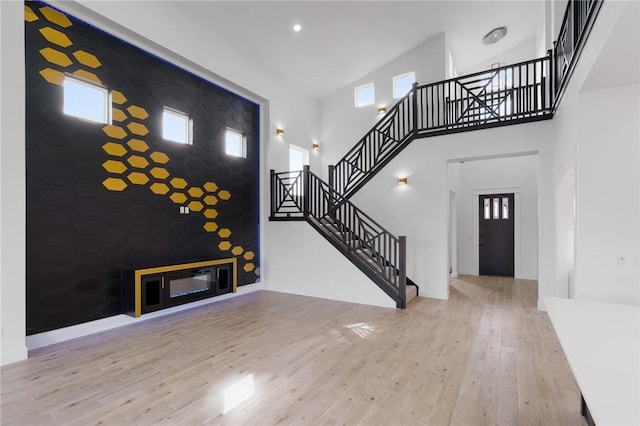 foyer entrance featuring light hardwood / wood-style floors and a high ceiling