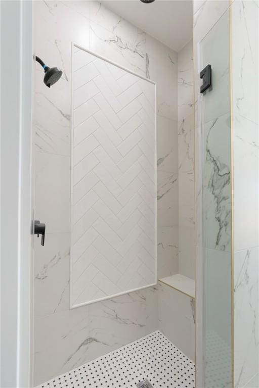 bathroom with a tile shower