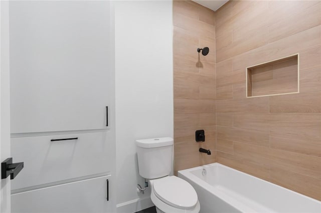 bathroom with toilet and tiled shower / bath combo