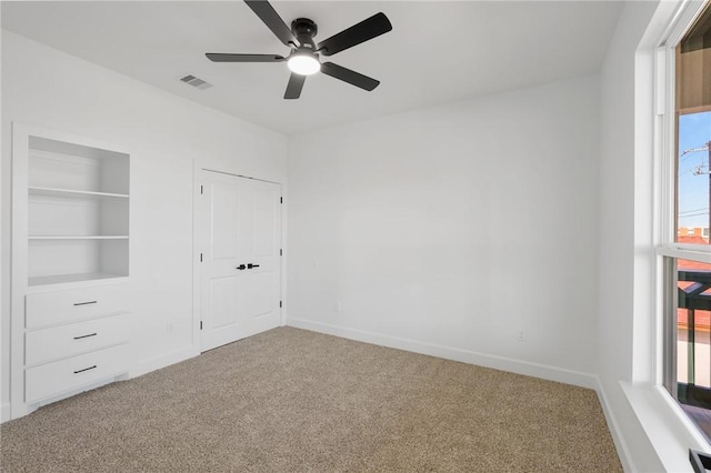 unfurnished bedroom featuring ceiling fan and carpet floors