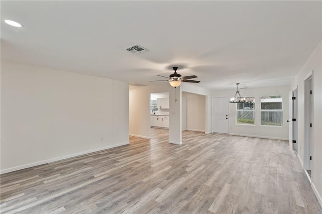 unfurnished living room with light hardwood / wood-style floors and ceiling fan with notable chandelier