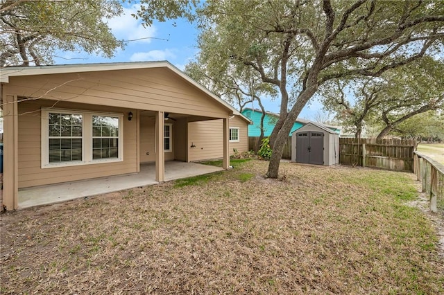 rear view of house featuring a shed, a yard, and a patio