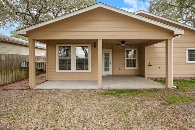 back of property featuring ceiling fan and a patio