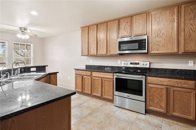 kitchen with dark stone countertops, sink, and stainless steel appliances