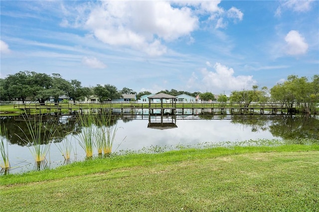 dock area featuring a water view and a yard