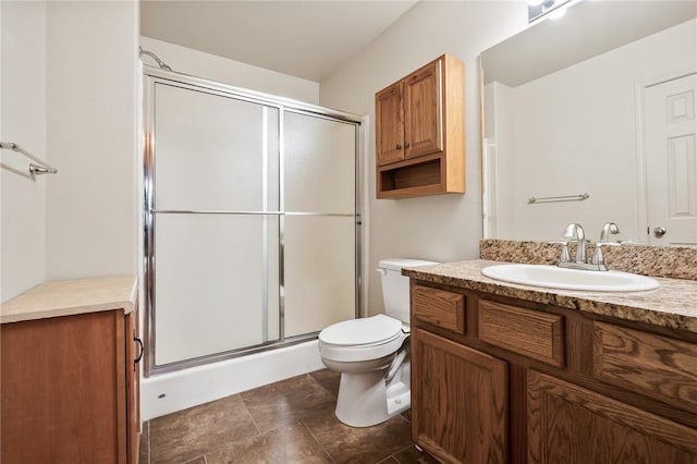 bathroom with vanity, a shower with shower door, and toilet