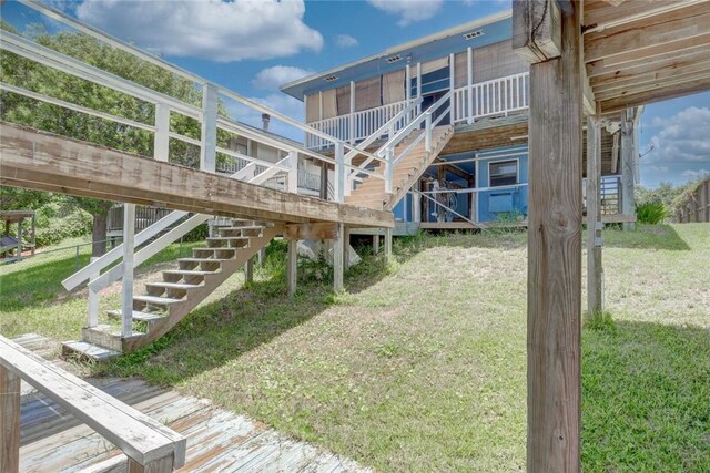 3410 Laguna Shrs, Corpus Christi, TX 78418 - rear view of property featuring stairway and a yard