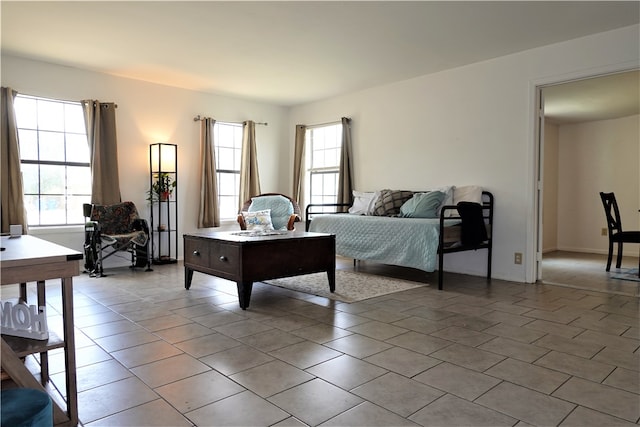 tiled bedroom featuring multiple windows