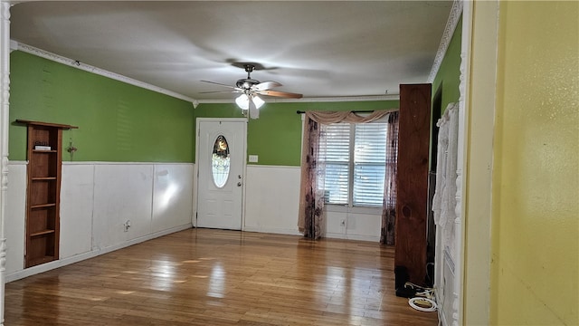 foyer featuring ornamental molding, hardwood / wood-style flooring, and ceiling fan