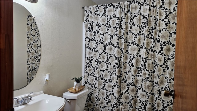 bathroom featuring sink and toilet