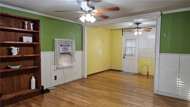 interior space with ceiling fan, light wood-type flooring, and ornamental molding