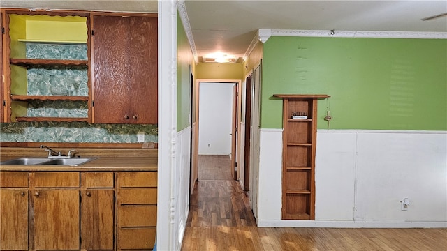 kitchen with tasteful backsplash, sink, and hardwood / wood-style flooring