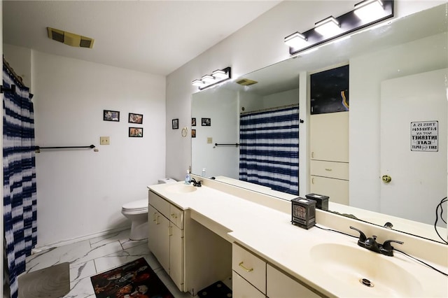 bathroom featuring curtained shower, vanity, and toilet