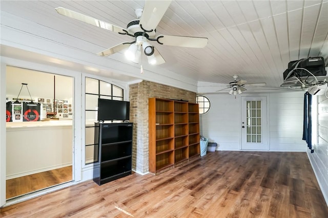 interior space with wooden ceiling, ceiling fan, brick wall, and hardwood / wood-style flooring