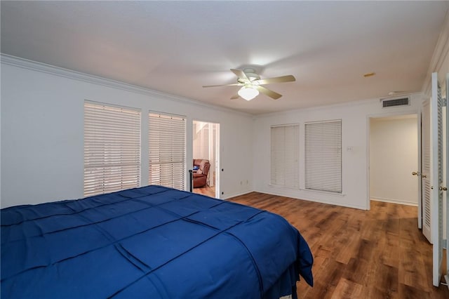 bedroom featuring a closet, hardwood / wood-style flooring, ceiling fan, and ornamental molding