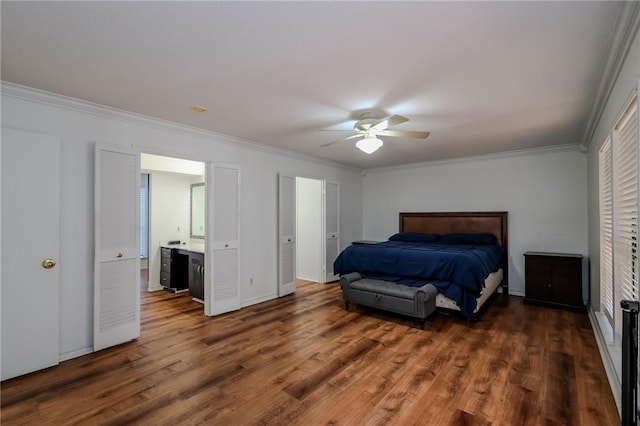 bedroom featuring ceiling fan, dark hardwood / wood-style flooring, ornamental molding, and connected bathroom