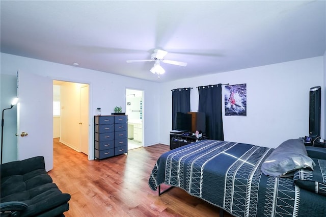 bedroom featuring ensuite bathroom, ceiling fan, and wood-type flooring