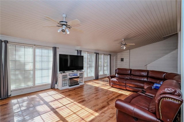 living room with wood walls, wood ceiling, vaulted ceiling, and hardwood / wood-style flooring