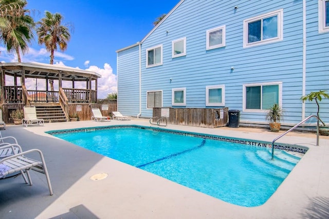 view of swimming pool with a deck, a patio, and a gazebo