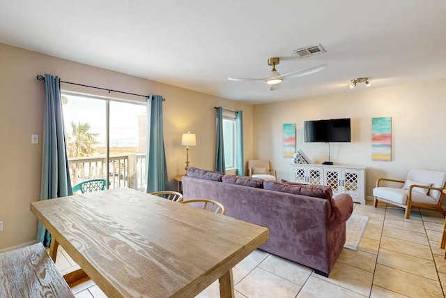 living room with ceiling fan and light tile patterned floors