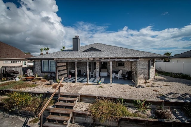 15957 San Felipe Dr, Corpus Christi, TX 78418 - rear view of house with brick siding, a chimney, fence, and a pergola