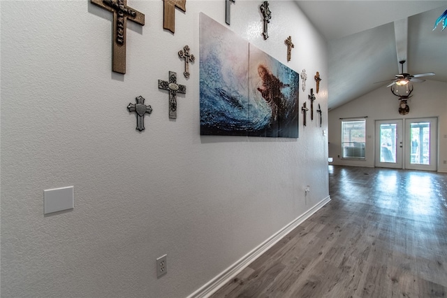 corridor featuring vaulted ceiling, french doors, and wood-type flooring