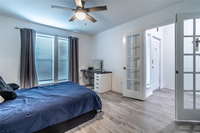 bedroom with ceiling fan, light wood-type flooring, and french doors