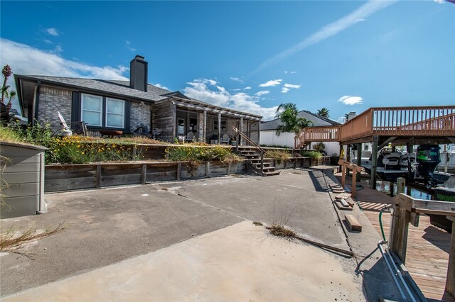 exterior space featuring a deck and a boat dock