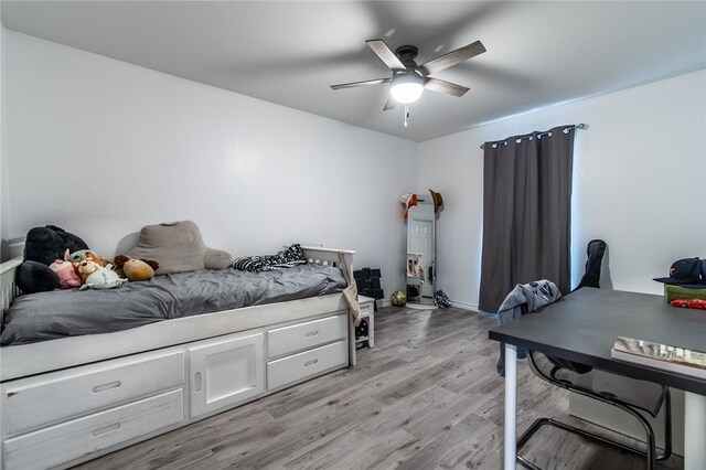 bedroom with light hardwood / wood-style floors and ceiling fan