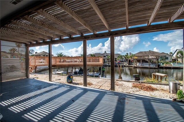 view of patio / terrace featuring a water view and a boat dock