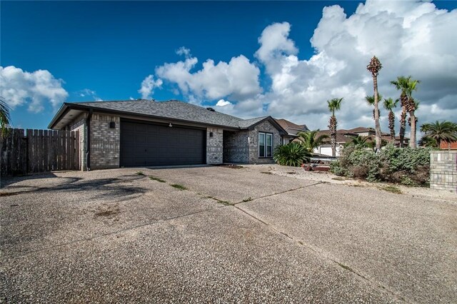 15957 San Felipe Dr, Corpus Christi, TX 78418 - ranch-style home with concrete driveway, an attached garage, fence, and brick siding
