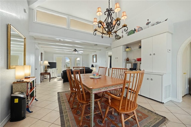 tiled dining space featuring beam ceiling, french doors, and ceiling fan