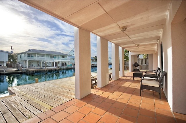 view of patio featuring a dock and a water view