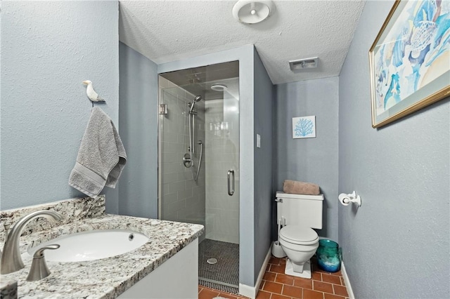 bathroom featuring toilet, vanity, walk in shower, tile patterned floors, and a textured ceiling