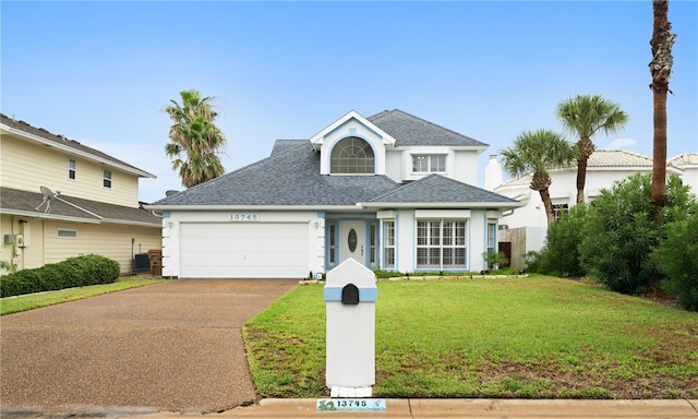 front facade with a garage and a front lawn